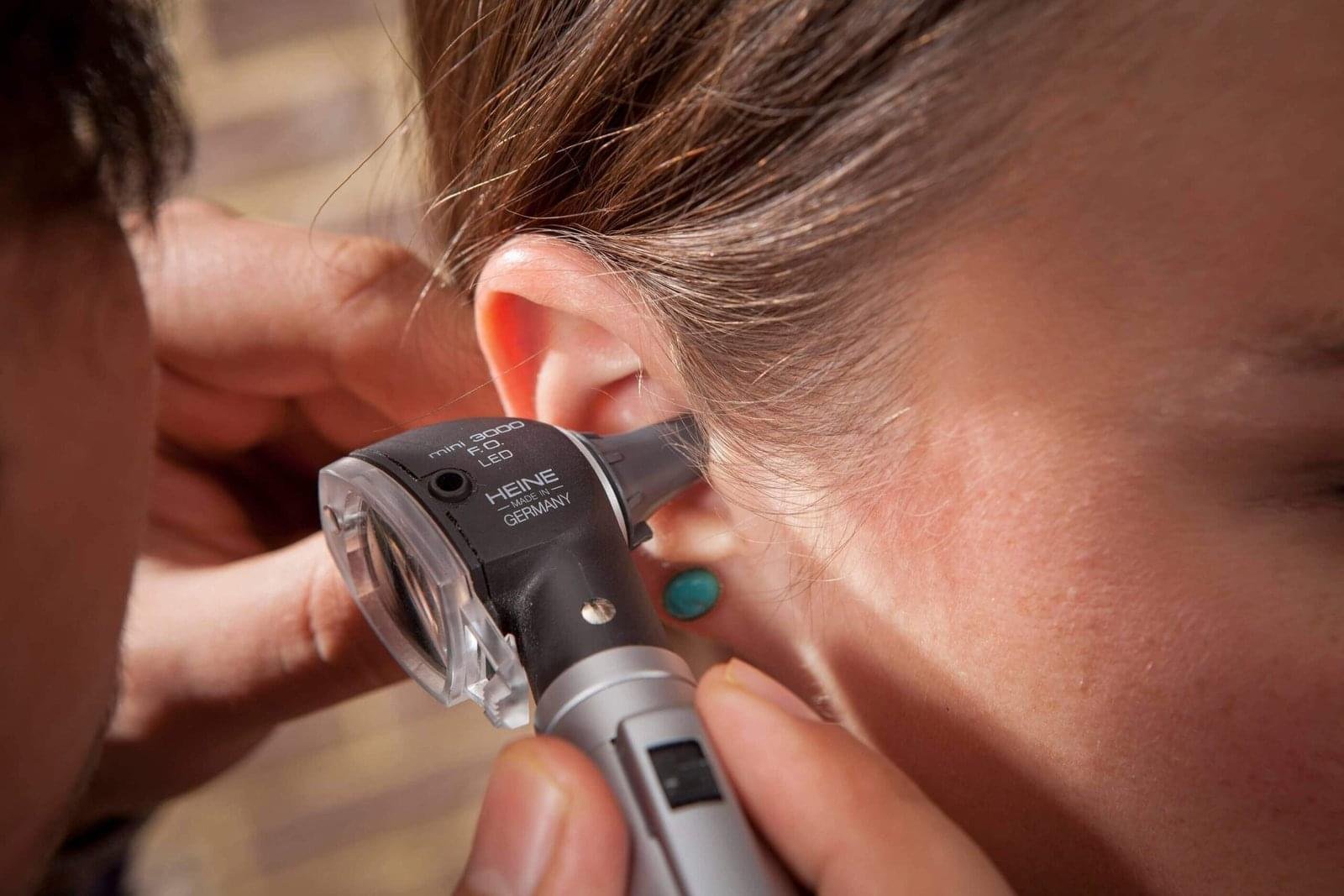 audiologist-looking-in-patients-ear - EarMart Hearing Solutions audiologist-looking-in-patients-ear